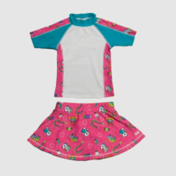 Pink and teal children's swimsuit set with skull pattern on a light gray background