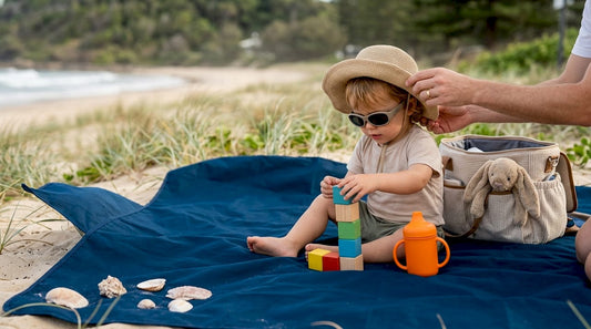 Toddler with sunglasses and sun hat outdoors