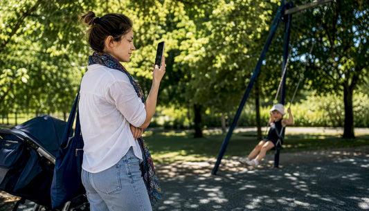 Mother measuring playground noise with smartphone
